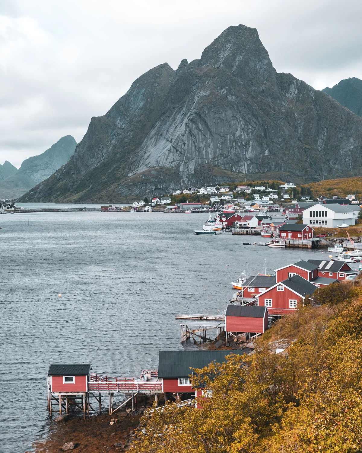Norwegian coastal village beneath dramatic mountains